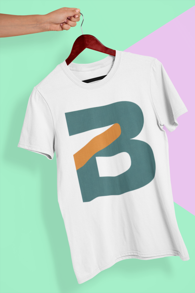 A hand holding a wooden hanger with a custom printed white t-shirt featuring a stylized letter B logo, showcasing custom merchandise printing in Los Angeles, CA.