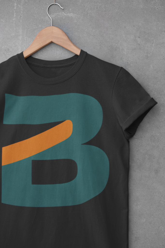 A black custom-printed t-shirt with a stylized teal and orange letter B logo hanging on a wooden hanger, demonstrating custom screen printing in Phoenix, AZ.