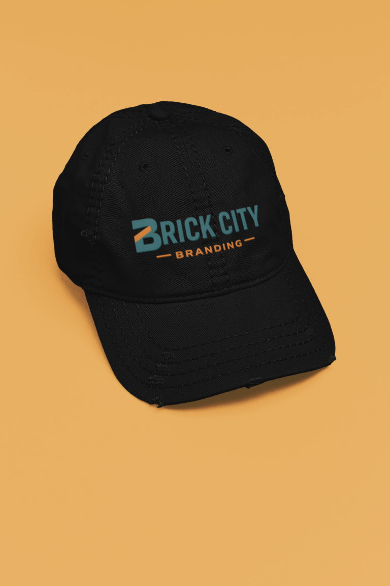 Black distressed dad hat featuring the Brick City Branding logo on an orange background in Newark, NJ.