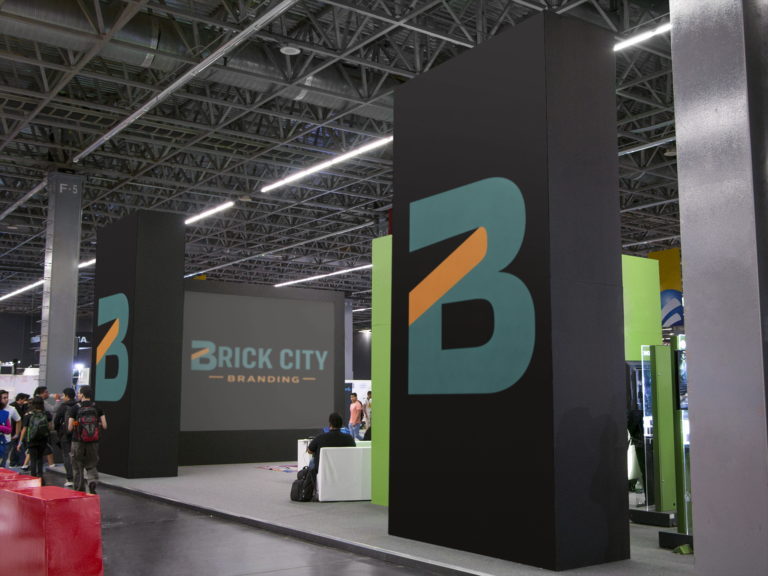 Large trade show booth exhibit featuring black pillars and screens branded with the Brick City Branding logo in Newark, NJ.