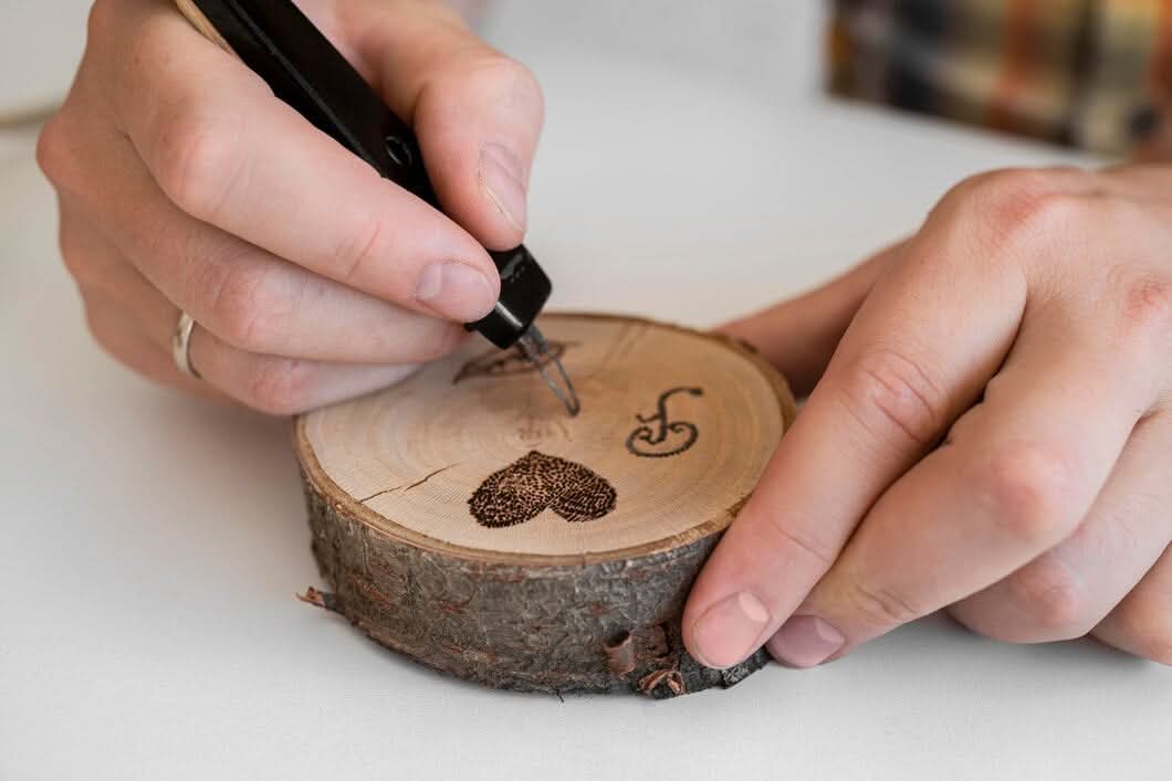 A craftsman in a flannel shirt and apron working at a wooden workbench, carefully sanding and finishing a custom wood project in a sunlit shop.