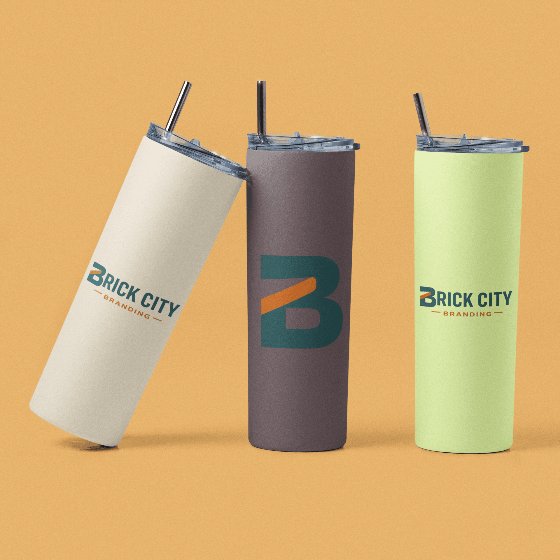 Three insulated skinny tumblers in cream, mauve and green with a printed logo and steel straws