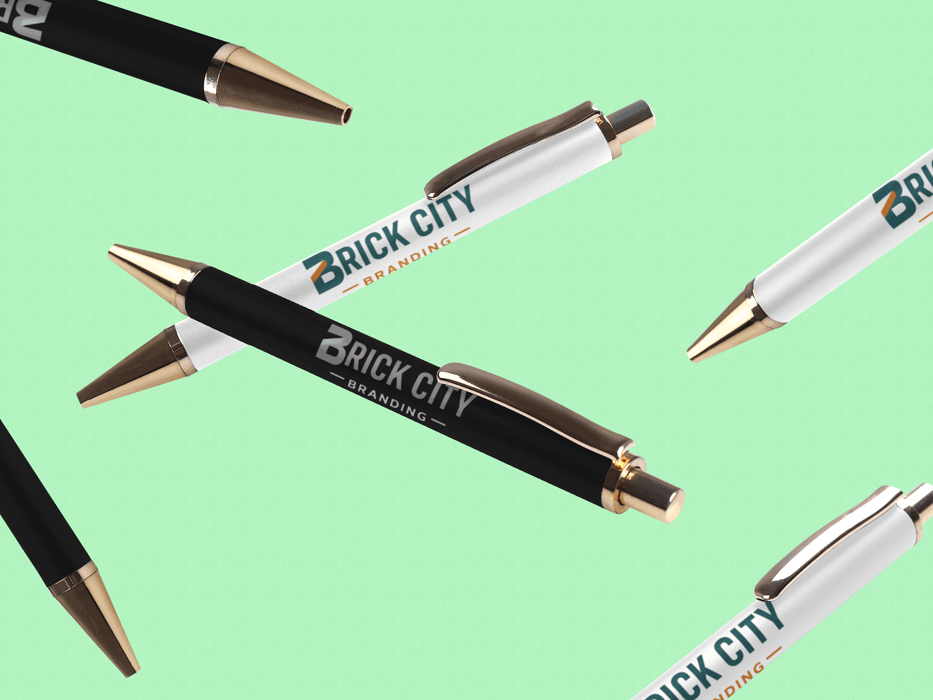 Black and white branded pens with gold accents and a printed logo