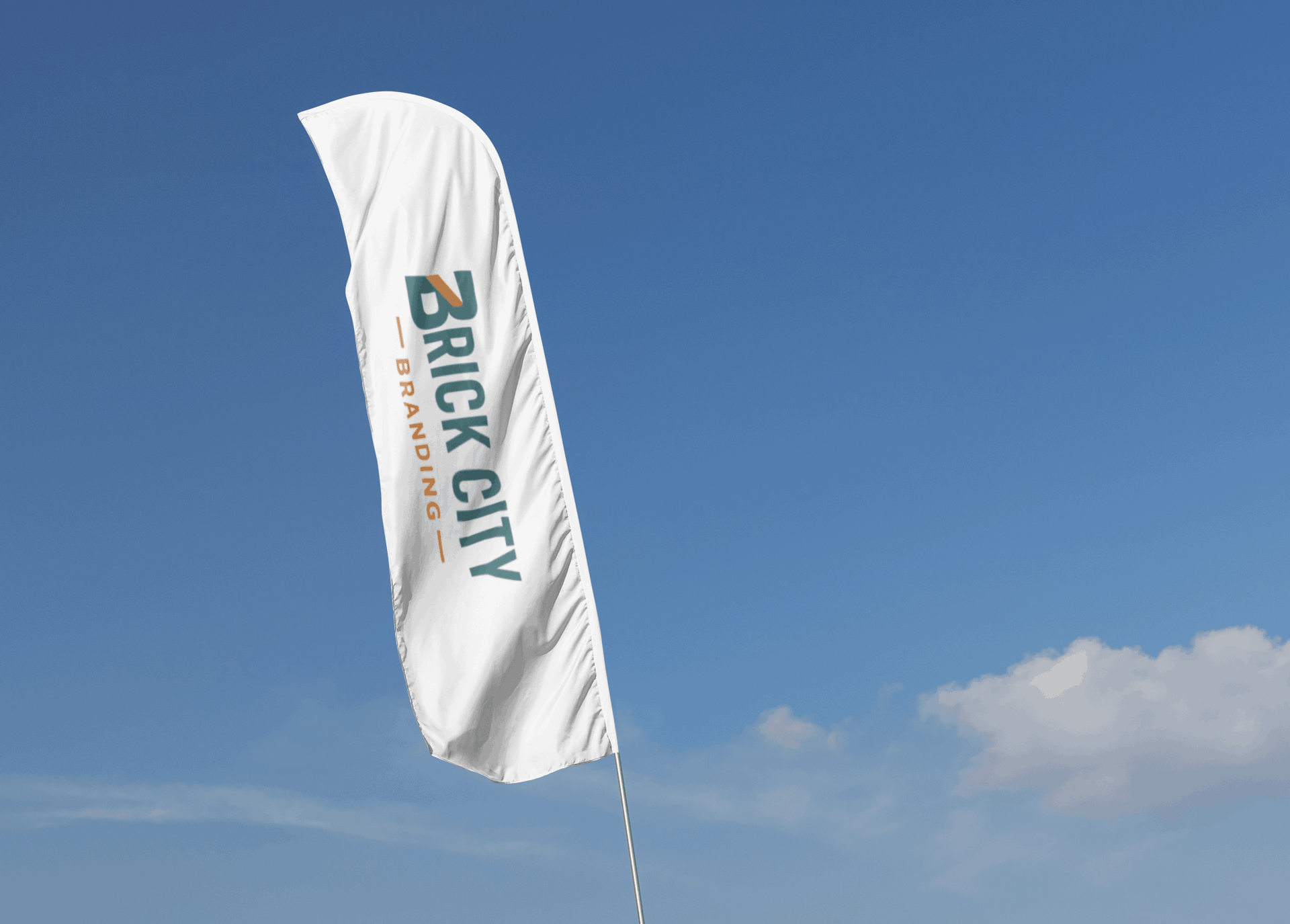 Branded feather flag outside a building against a blue sky