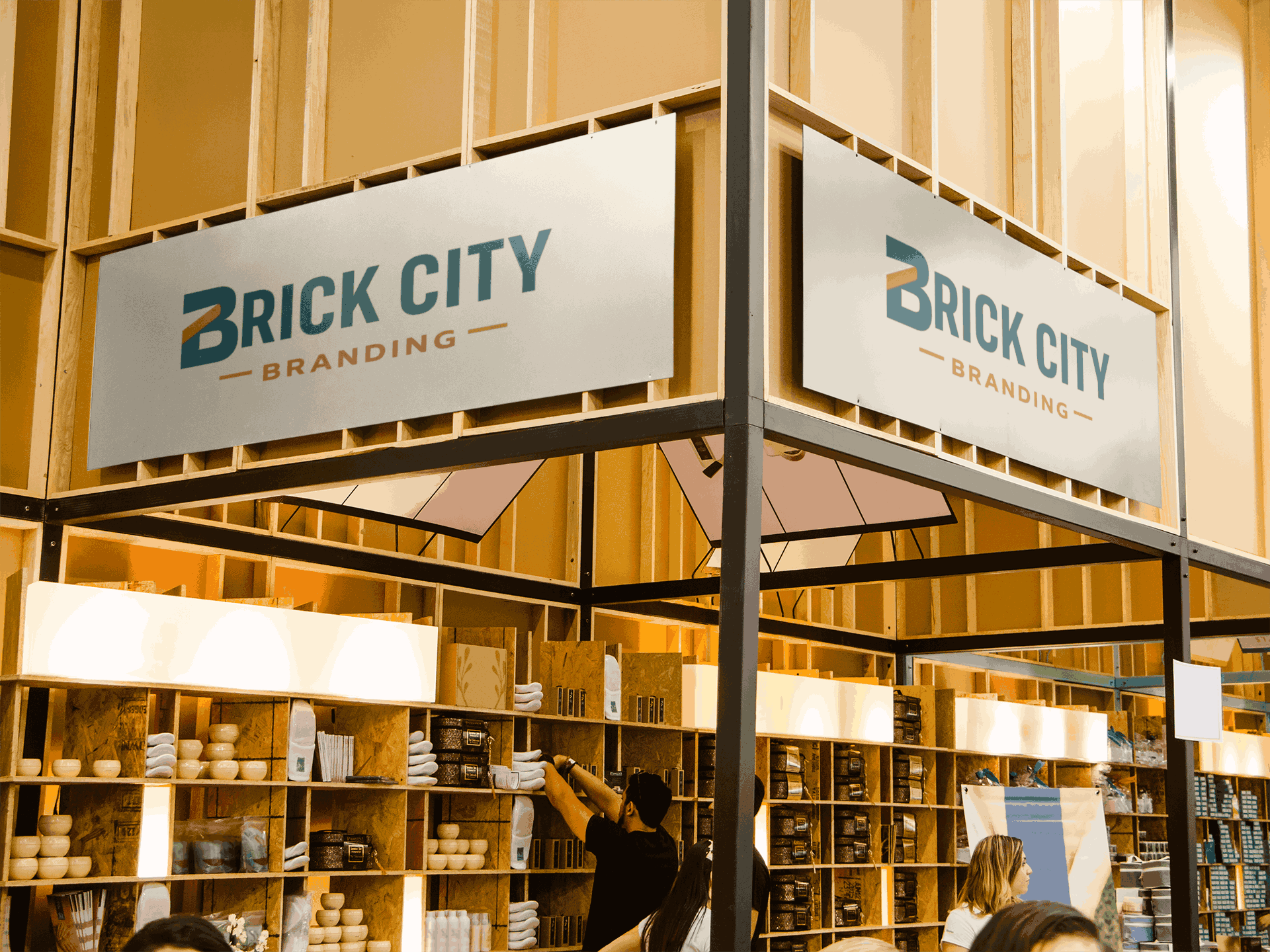 Dual overhead metal signage featuring the Brick City Branding logo mounted on a wooden frame for a professional trade show booth.