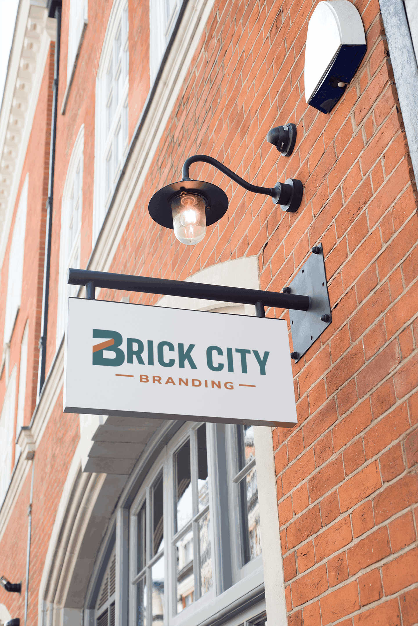 Projecting blade sign with a gooseneck light mounted on a brick storefront