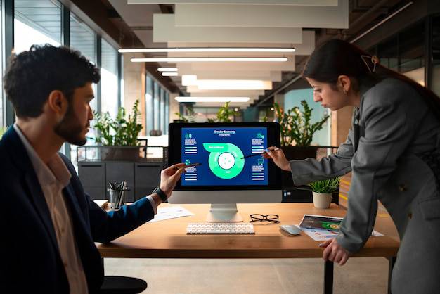 Two business professionals analyzing an infographic flowchart on a desktop computer screen in Newark, NJ.