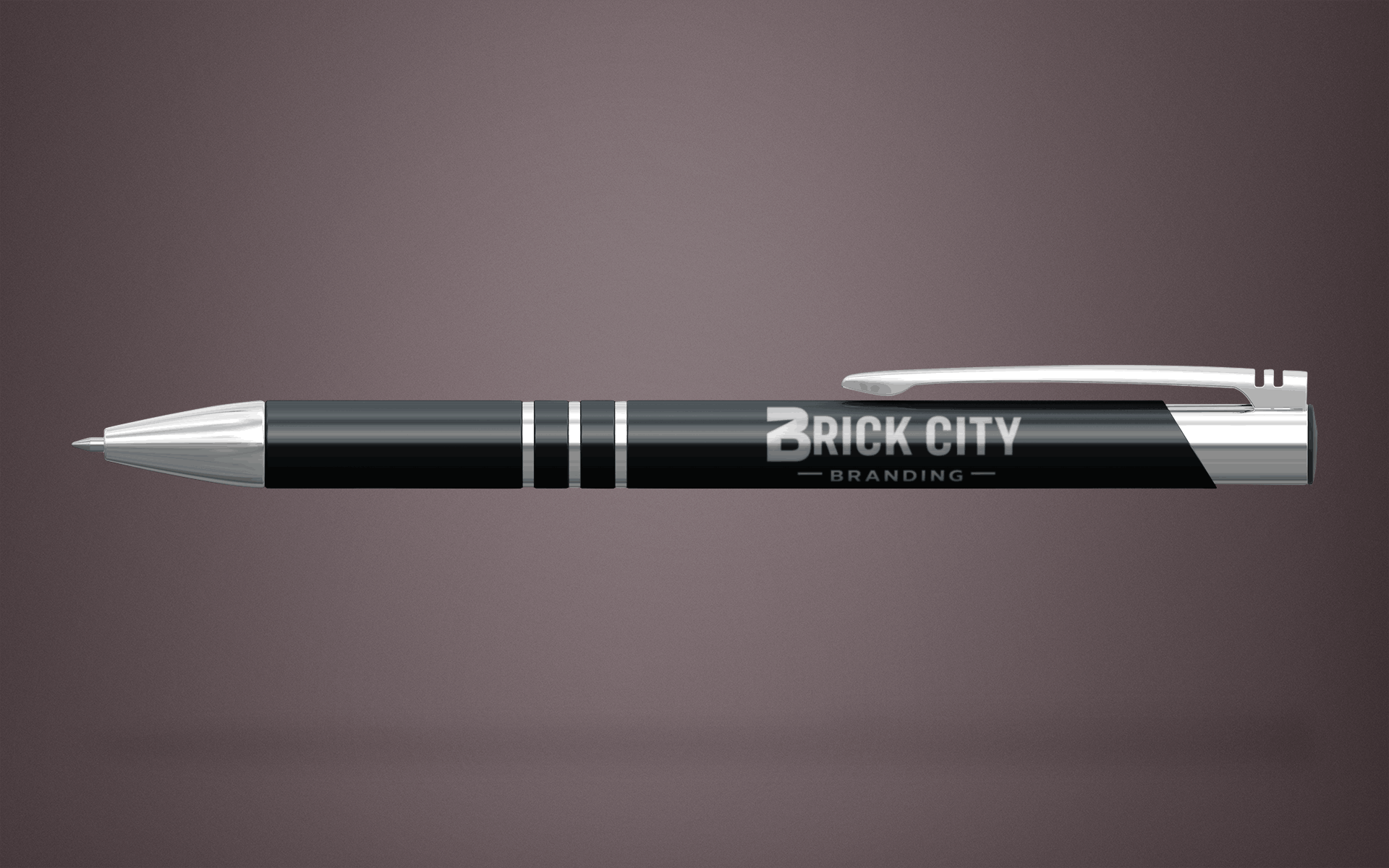 A luxury black and chrome metal executive pen with the Brick City Branding logo laser-engraved on the barrel, featuring silver accents.