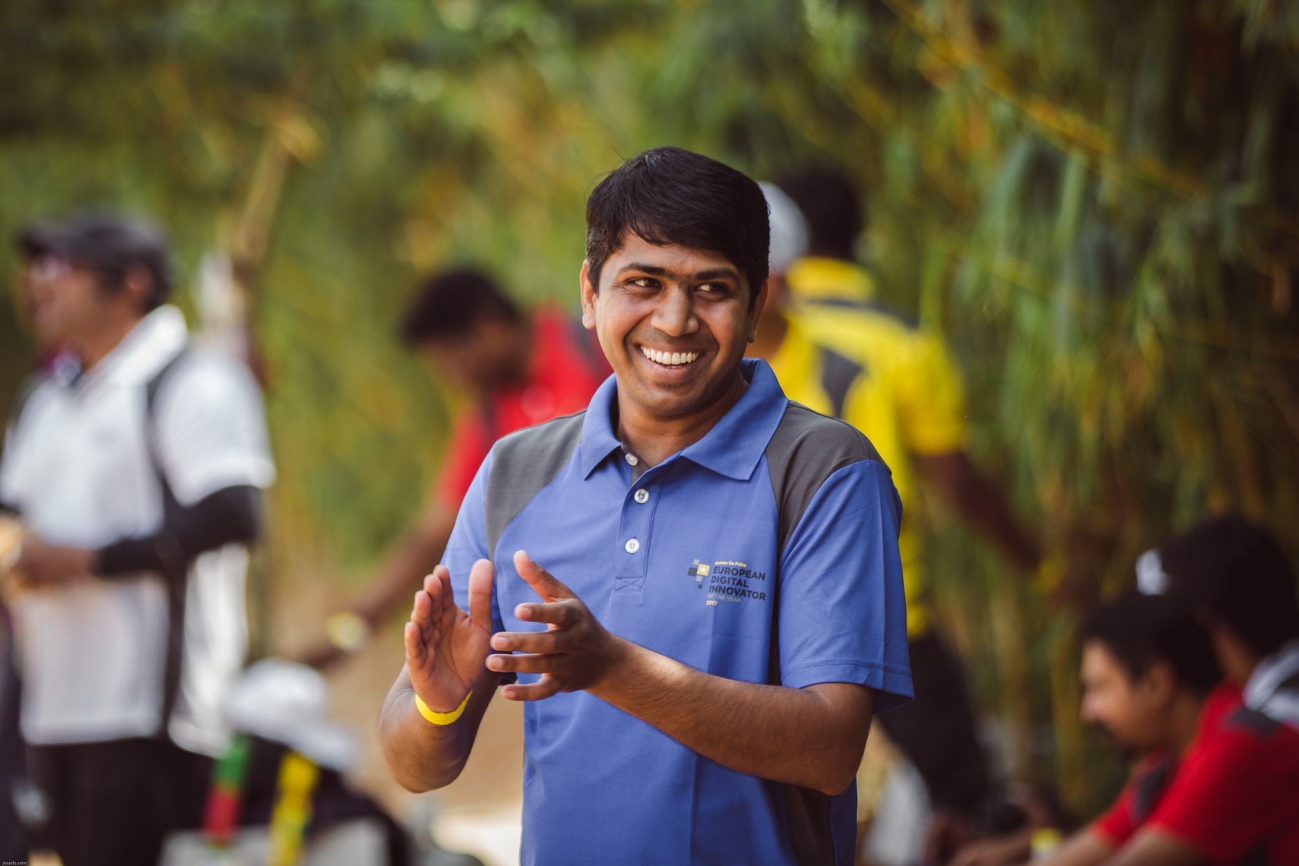 Team member wearing a branded polo shirt at a community event